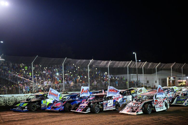 DIRTcar UMP Modifieds fly Summit Racing flags before the Feature at a dirt racing event