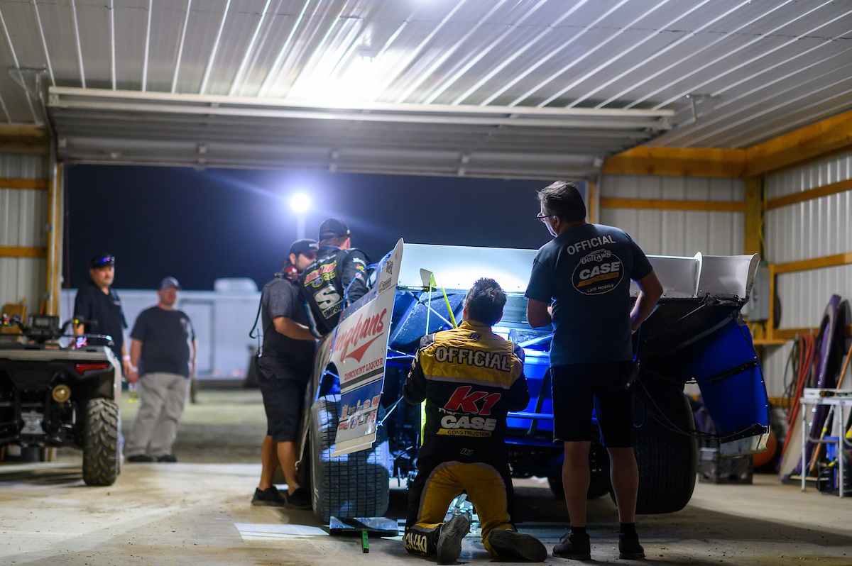 DIRTcar Officials from the WOrld of Outlaws Late Model Series inspect the winning car after a dirt racing event. 