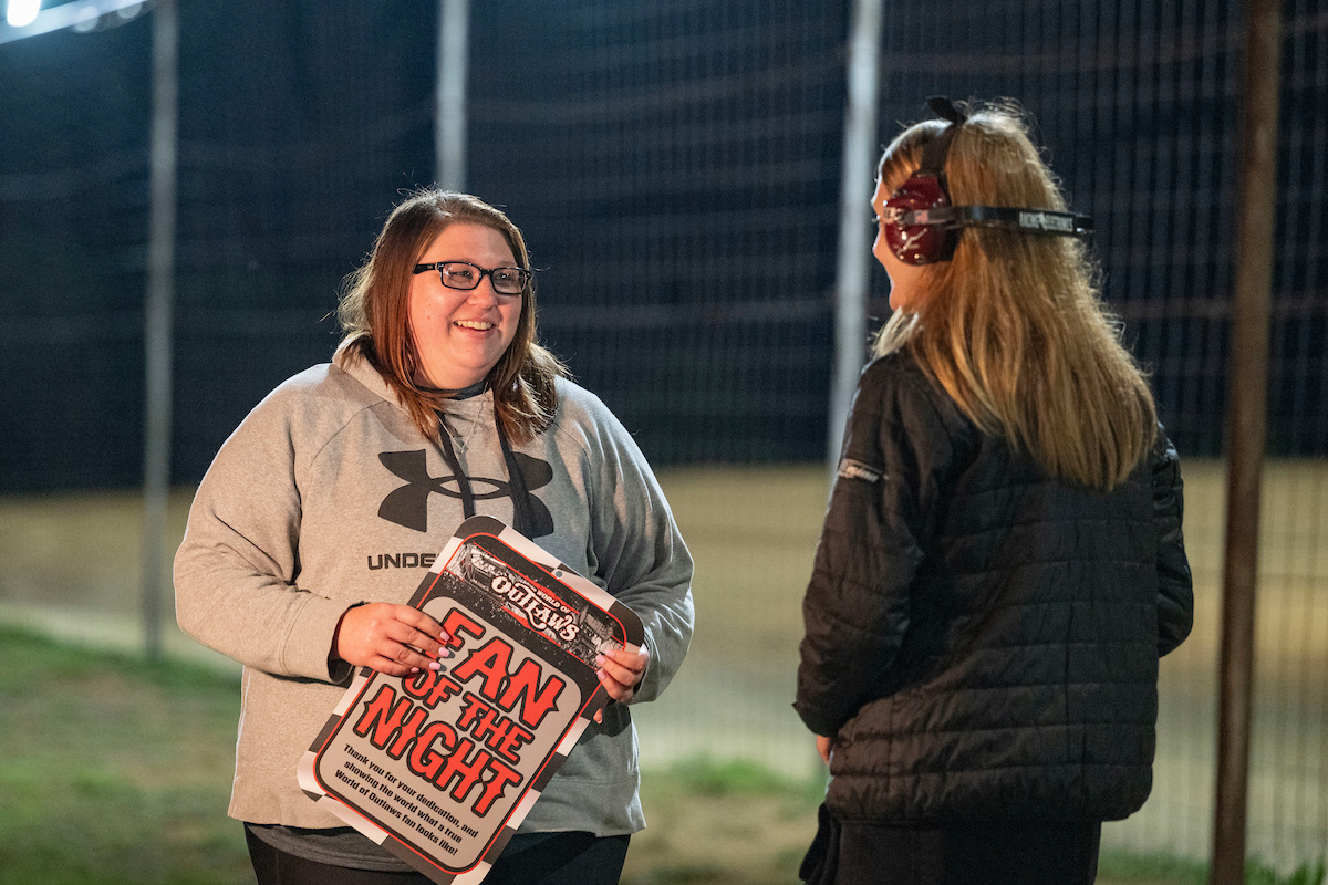 A fan is recognized as the Fan of the Night during a break in the action at a dirt racing event. 